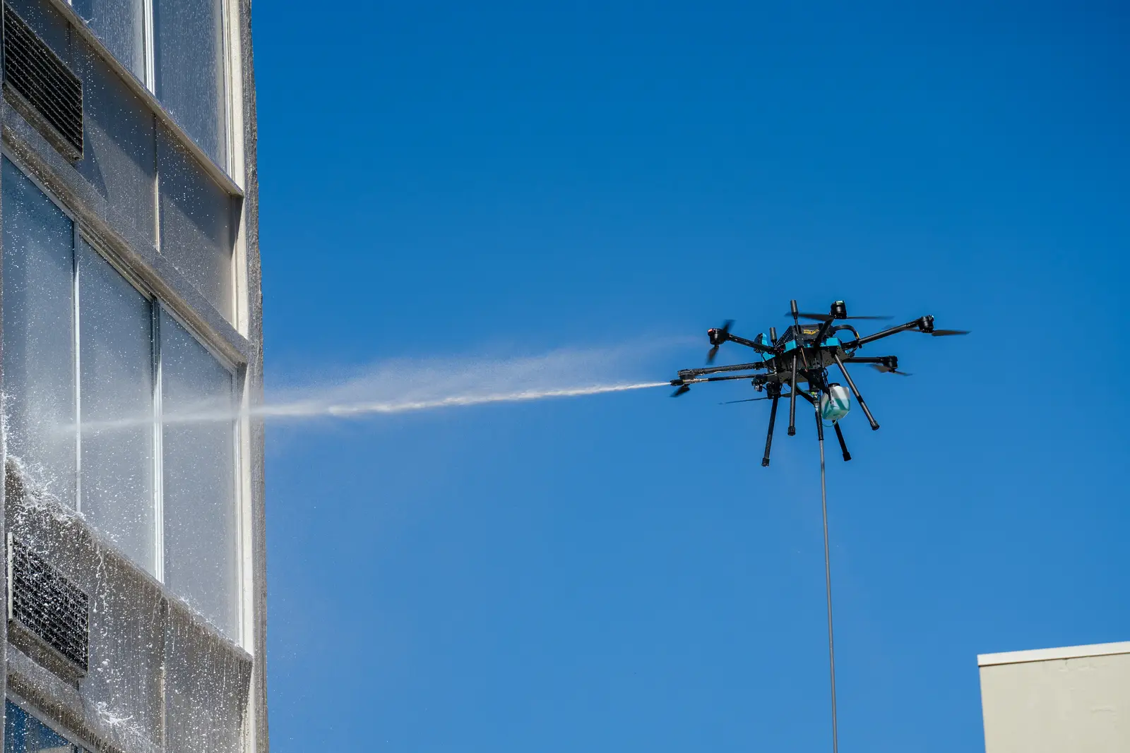 A Lucid Bots Sherpa drone cleaning upper-level exterior windows